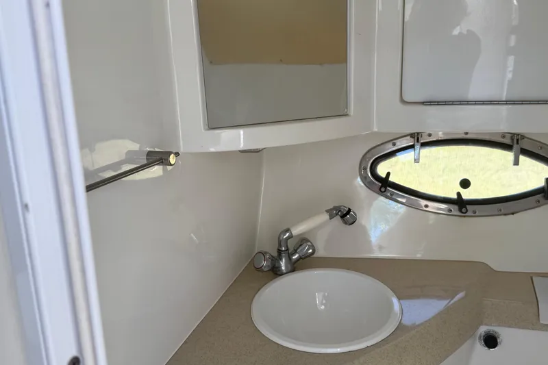 Slide: The Image of Interior cabin of a 1999 Cobalt 293 boat with beige upholstery and control panels. - 39