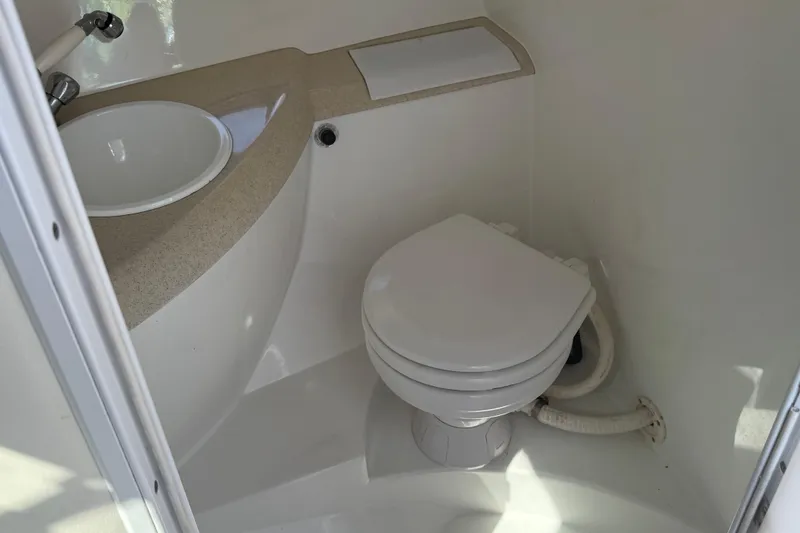 Slide: The Image of Interior view of a 1999 Cobalt 293 boat cabin with open door and sunny exterior. - 40