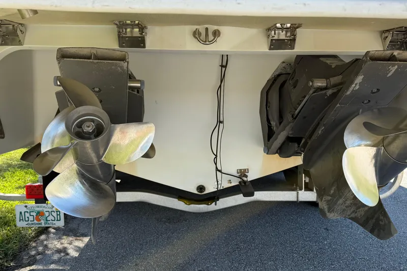 Slide: The Image of 1999 Cobalt 293 boat on trailer, parked on a sunny residential street with palm trees. - 5