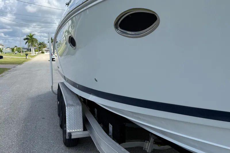 Slide: The Image of 1999 Cobalt 293 boat interior with beige seating and triangular table. - 59
