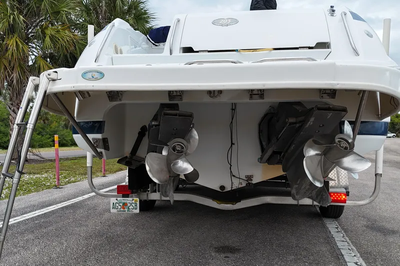 Slide: The Image of Covered 1999 Cobalt 293 boat on trailer, parked outdoors. - 67