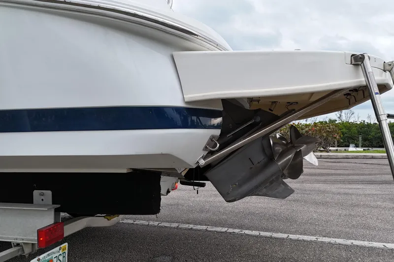 Slide: The Image of Covered 1999 Cobalt 293 boat on trailer, parked near palm trees. - 69