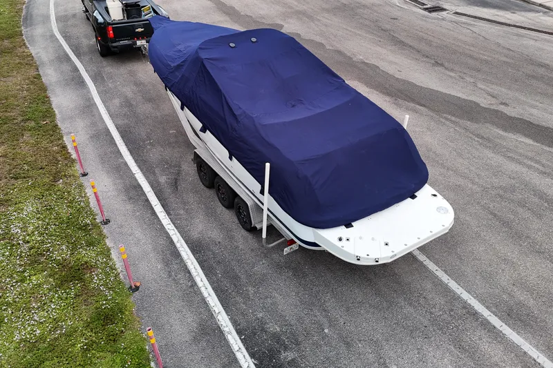Slide: The Image of Rear view of a 1999 Cobalt 293 boat with dual propellers on a trailer. - 71