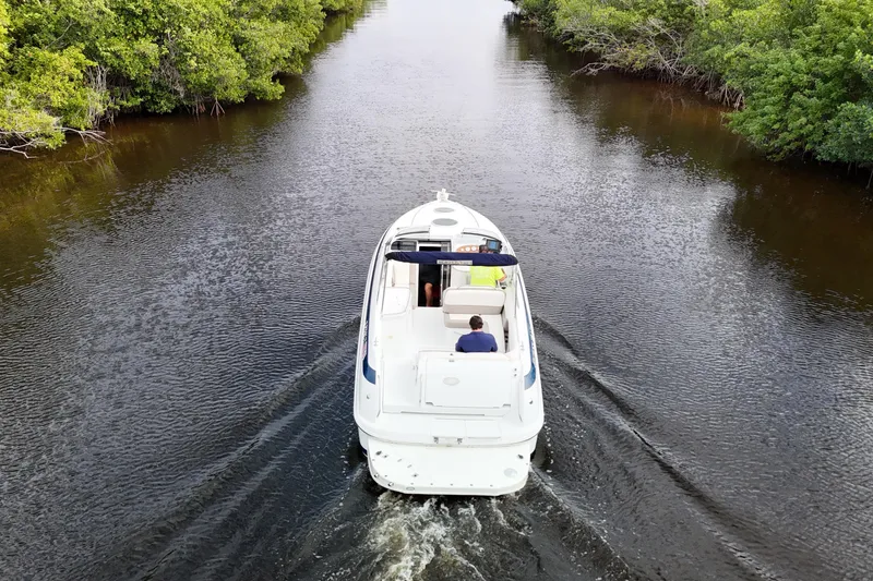 Slide: The Image of Covered 1999 Cobalt 293 boat on trailer, parked on a road, viewed from above. - 74