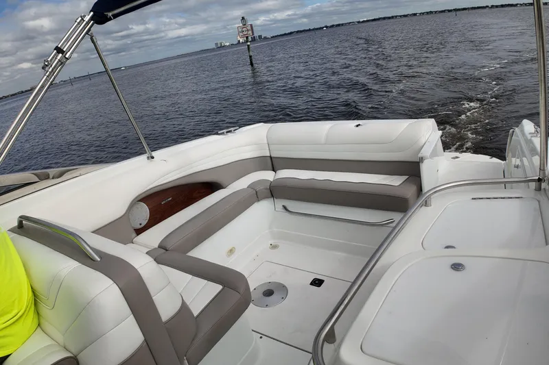 Slide: The Image of 1999 Cobalt 293 boat interior with white seating on a calm water backdrop. - 84