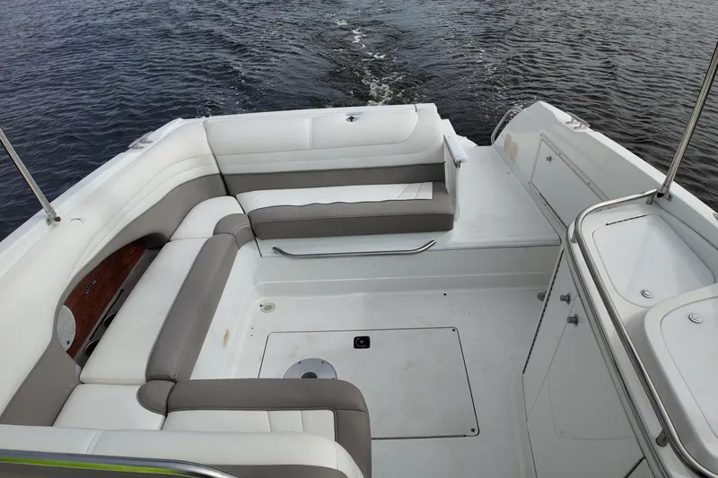 Slide: The Image of 1999 Cobalt 293 boat interior with white and gray seating on open water. - 85