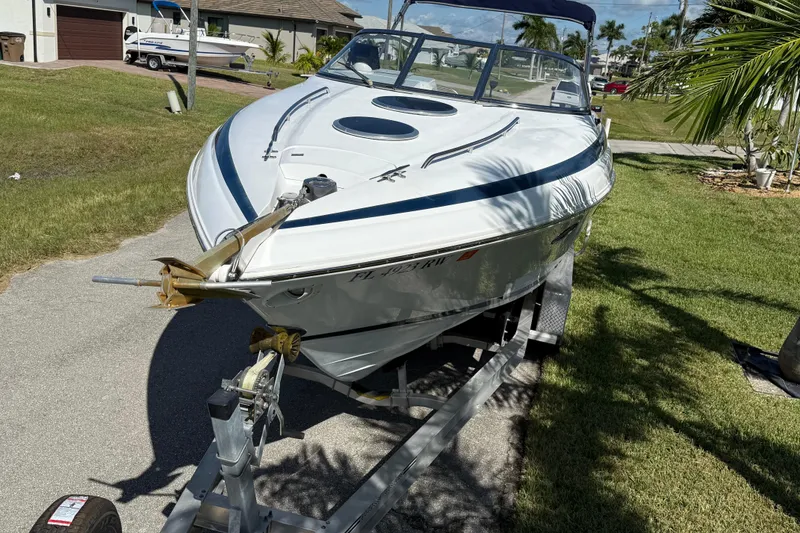 Slide: The Image of Rear view of a 1999 Cobalt 293 boat with dual propellers and Florida license plate. - 9