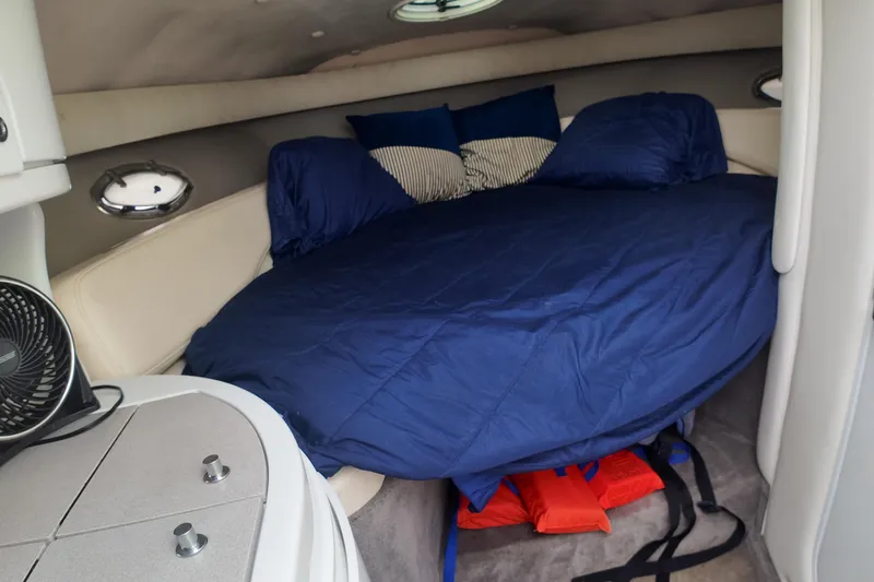 Slide: The Image of Interior cabin of a 1999 Cobalt 293 boat with a cozy bed setup. - 91
