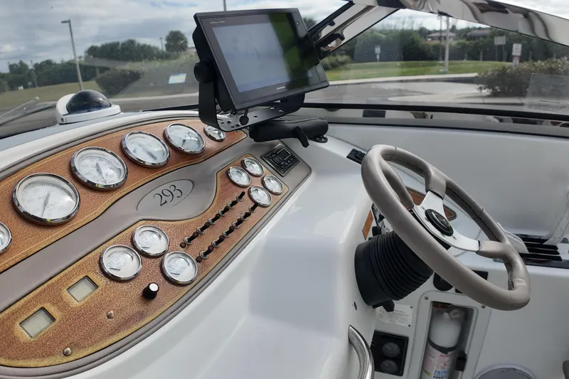 Slide: The Image of Dashboard of a 1999 Cobalt 293 boat with gauges and steering wheel. - 96