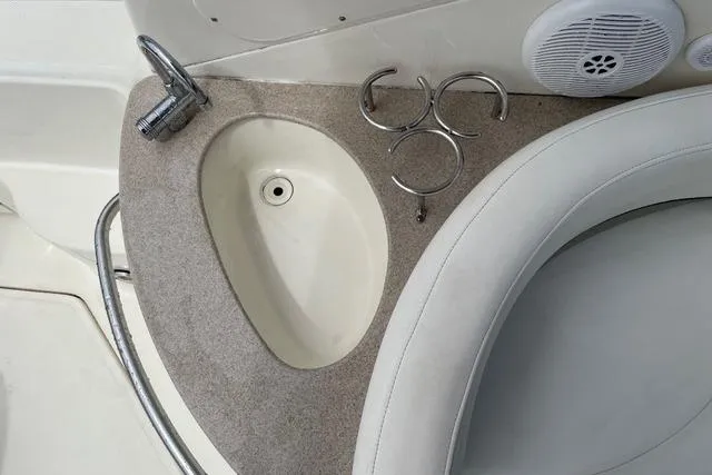 Slide: The Image of 2006 Sea Ray 260 Sundancer boat interior with sink and cup holders. - 10