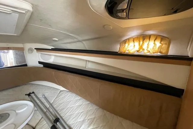 Slide: The Image of Interior cabin of 2006 Sea Ray 260 Sundancer with cozy sleeping area. - 15