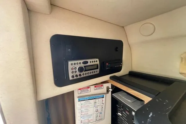 Slide: The Image of 2006 Sea Ray 260 Sundancer cabin interior with control panel and storage area. - 18