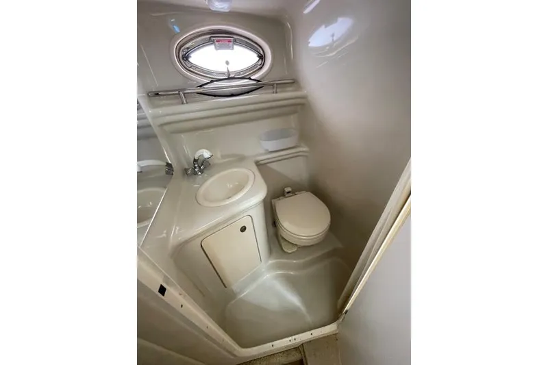 Slide: The Image of Compact bathroom in 2006 Sea Ray 260 Sundancer boat with sink and toilet. - 21