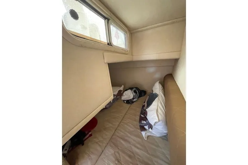 Slide: The Image of Interior cabin of 2006 Sea Ray 260 Sundancer with bed and window. - 23