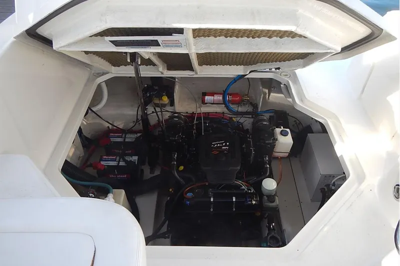 Slide: The Image of Engine compartment of a 2006 Sea Ray 260 Sundancer boat, showing detailed components. - 26