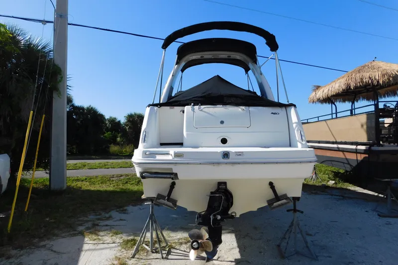 Slide: The Image of 2006 Sea Ray 260 Sundancer boat on stands, rear view, outdoors. - 3