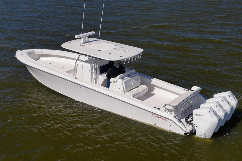 Slide: The Image of 2024 Bahama 41 RD boat with triple Mercury engines on open water. - 32