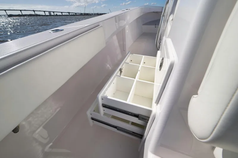 Slide: The Image of 2024 Bahama 41 RD boat with open storage compartments, ocean view in background. - 15