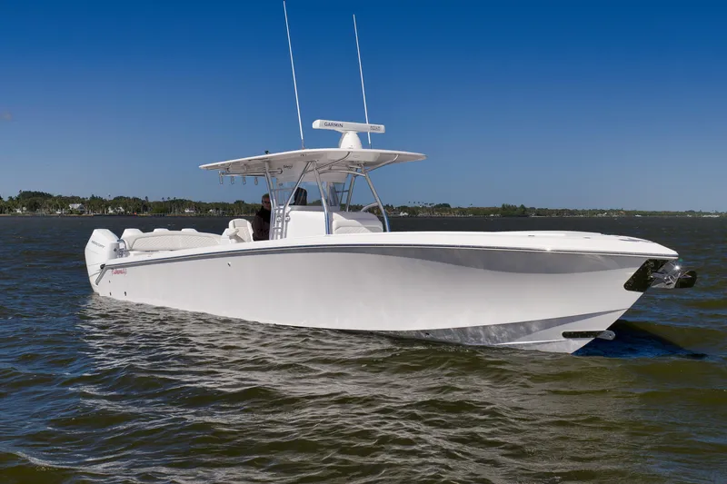 Slide: The Image of 2024 Bahama 41 RD boat cruising on open water under clear blue sky. - 31