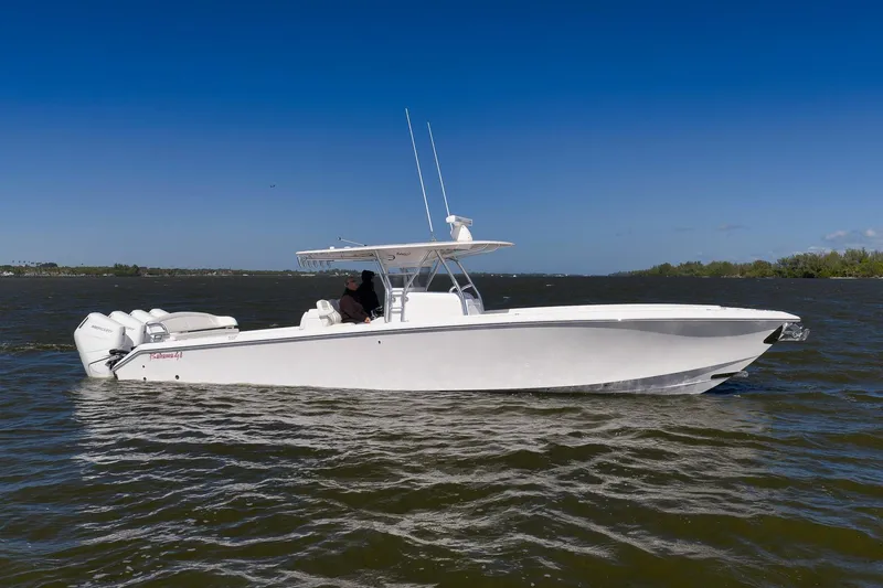 Slide: The Image of 2024 Bahama 41 RD boat cruising on a sunny day with clear blue skies. - 23