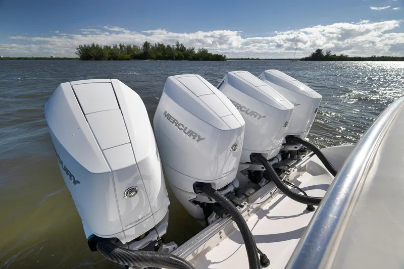 Slide: The Image of 2024 Bahama 41 RD boat with four Mercury outboard engines on a sunny day. - 19