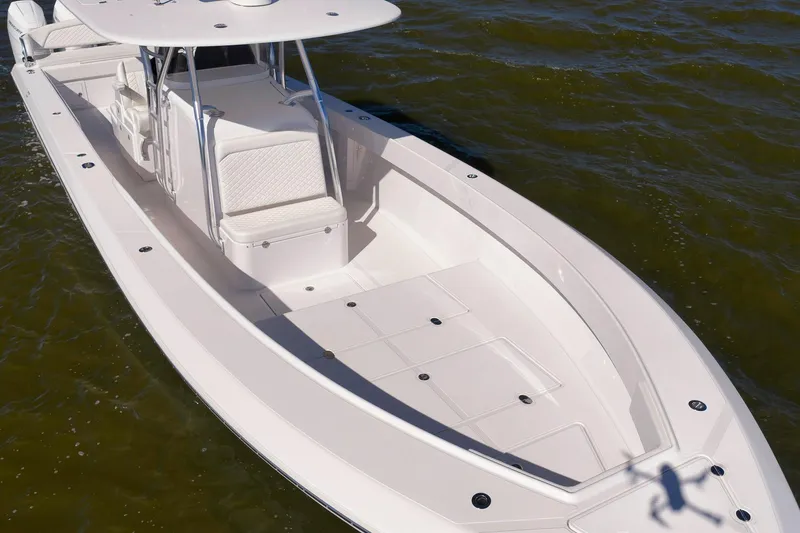 Slide: The Image of 2024 Bahama 41 RD boat on water, showcasing spacious deck and seating. - 29