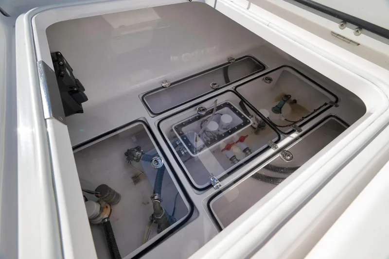 Slide: The Image of 2024 Bahama 41 RD boat storage compartment with visible plumbing and wiring components. - 20