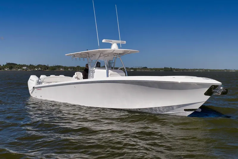 Slide: The Image of 2024 Bahama 41 RD boat cruising on open water under clear blue sky. - 25