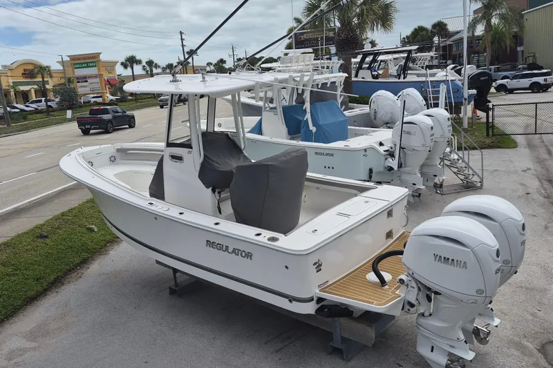 Slide: The Image of 2026 Regulator 23 boat with Yamaha engines displayed outdoors. - 12