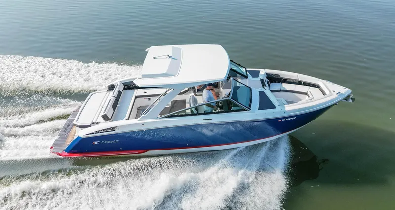 Slide: The Image of 2023 Cobalt R33 boat cruising on calm water, showcasing sleek design and performance. - 3