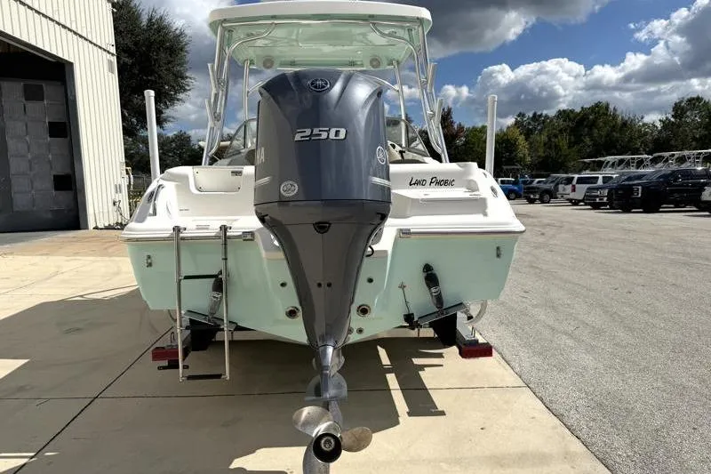 Slide: The Image of 2024 Key West 239 DFS boat with Yamaha 250 engine, parked outdoors. - 10