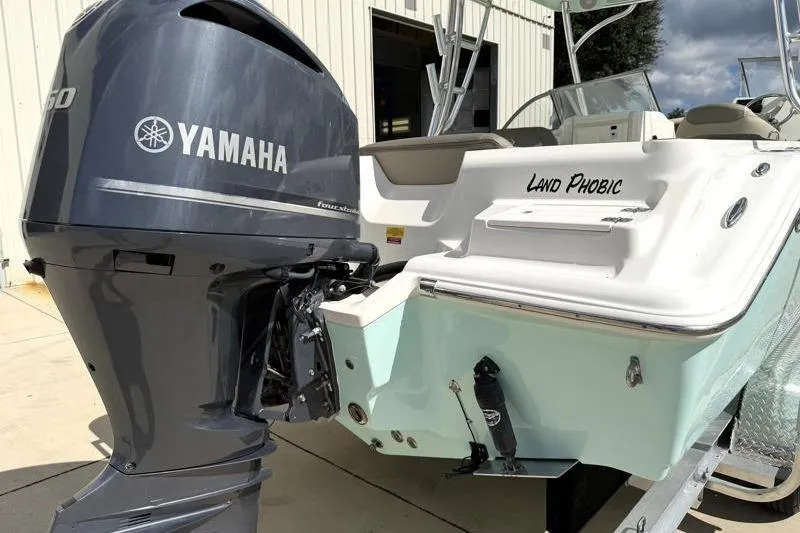 Slide: The Image of 2024 Key West 239 DFS boat with Yamaha engine, named "Land Phobic," parked outside. - 12