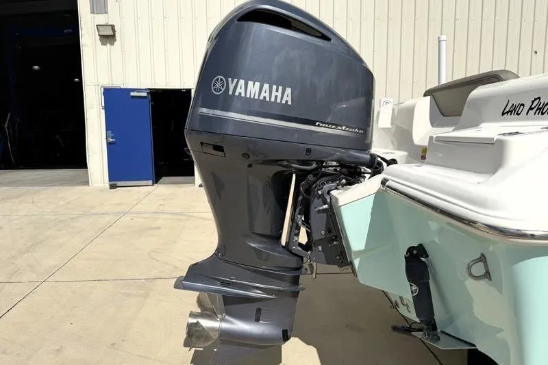 Slide: The Image of 2024 Key West 239 DFS boat with Yamaha outboard motor in a sunny marina. - 13