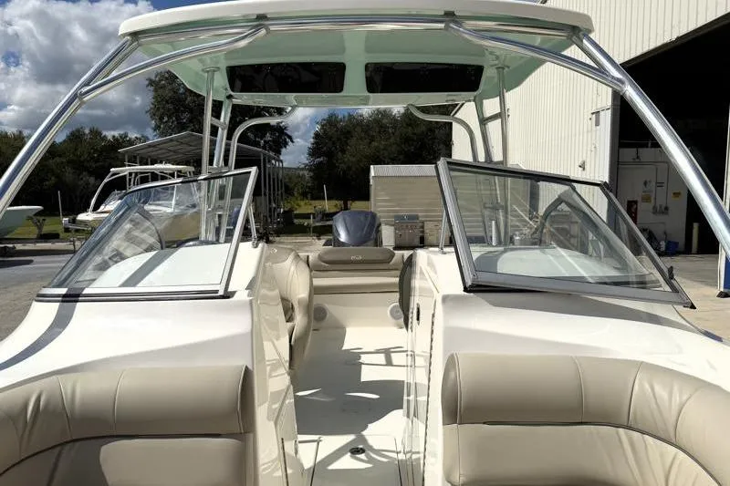 Slide: The Image of 2024 Key West 239 DFS boat interior with open seating and windshield, docked outdoors. - 17