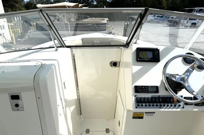 Slide: The Image of 2024 Key West 239 DFS boat dashboard with steering wheel and navigation system. - 24