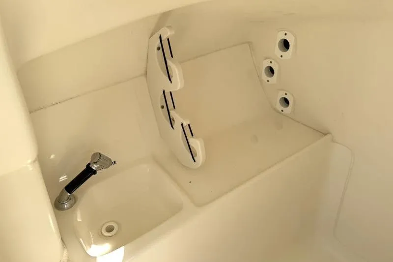 Slide: The Image of 2024 Key West 239 DFS boat interior with rod holders and sink. - 28