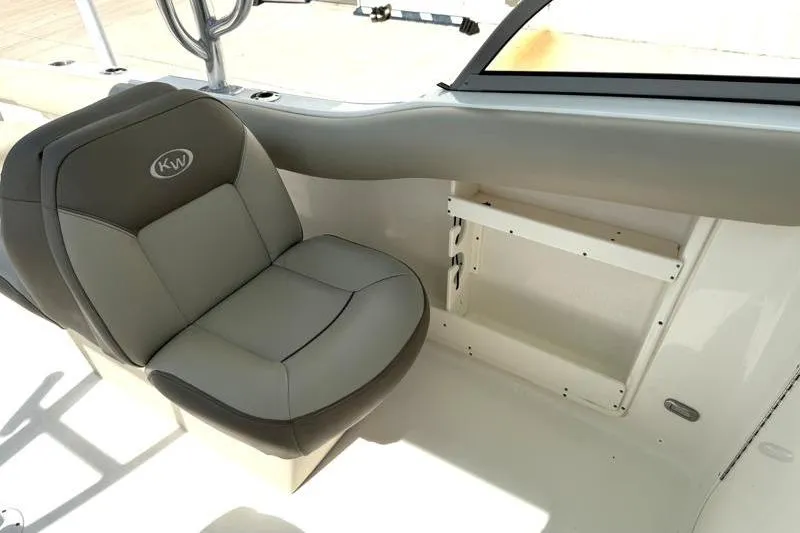 Slide: The Image of 2024 Key West 239 DFS boat interior with gray seating and storage compartment. - 29