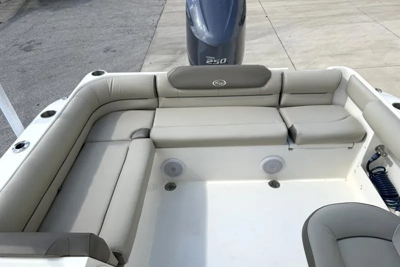 Slide: The Image of 2024 Key West 239 DFS boat interior with cushioned seating and Yamaha 250 engine. - 32