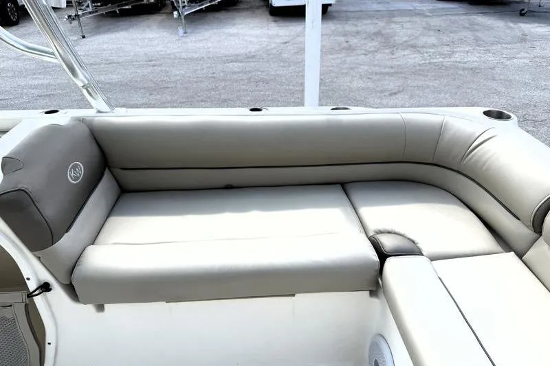 Slide: The Image of 2024 Key West 239 DFS boat interior with cushioned seating and cup holders. - 33