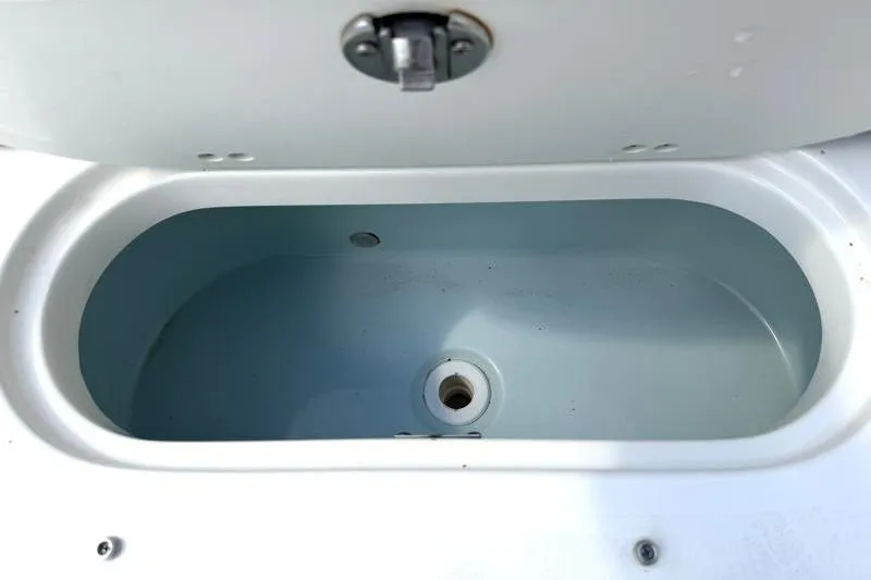 Slide: The Image of Livewell compartment on a 2024 Key West 239 DFS boat, featuring a clean interior. - 35