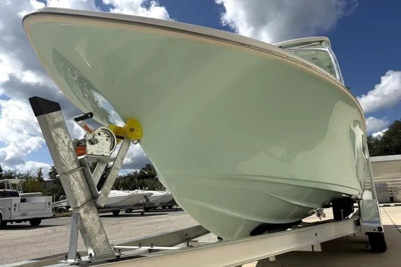 Slide: The Image of 2024 Key West 239 DFS boat on trailer under cloudy sky. - 9