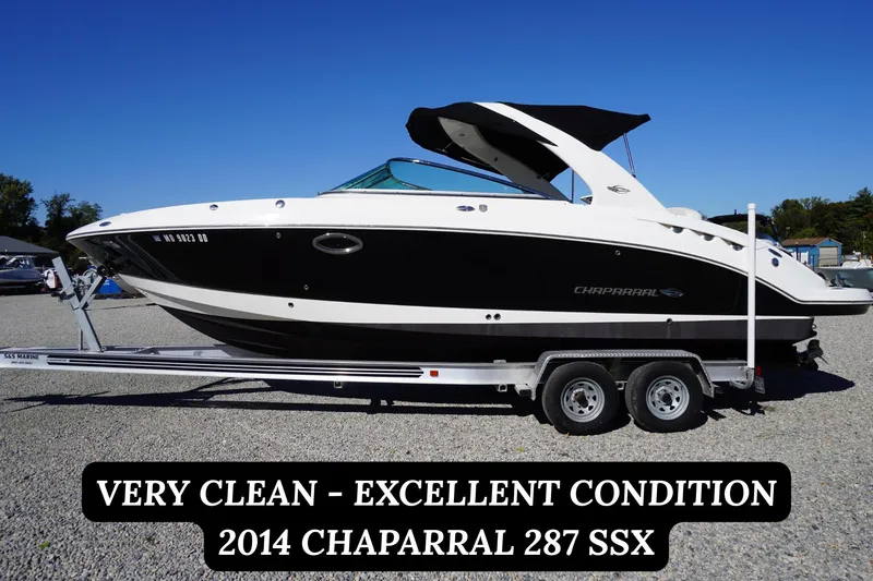 The Image of 2014 Chaparral 287 SSX boat on trailer, excellent condition, clear blue sky background. - 0