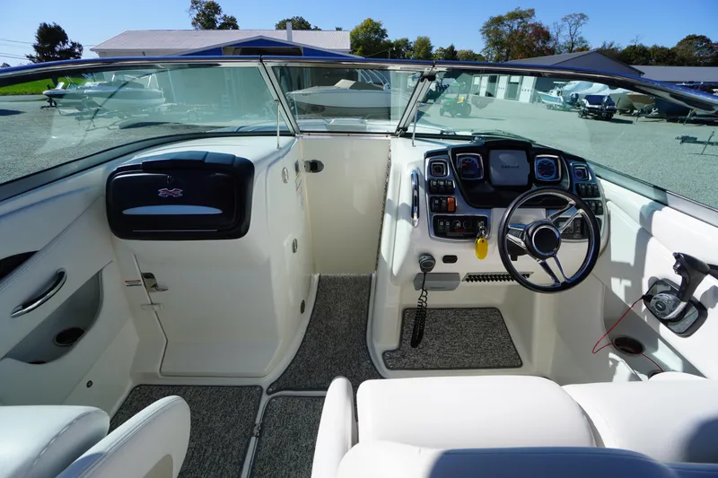 Slide: The Image of 2014 Chaparral 287 SSX boat cockpit with steering wheel and control panel. - 13