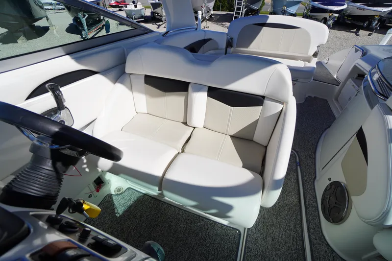 Slide: The Image of 2014 Chaparral 287 SSX boat interior with plush seating and steering wheel. - 15