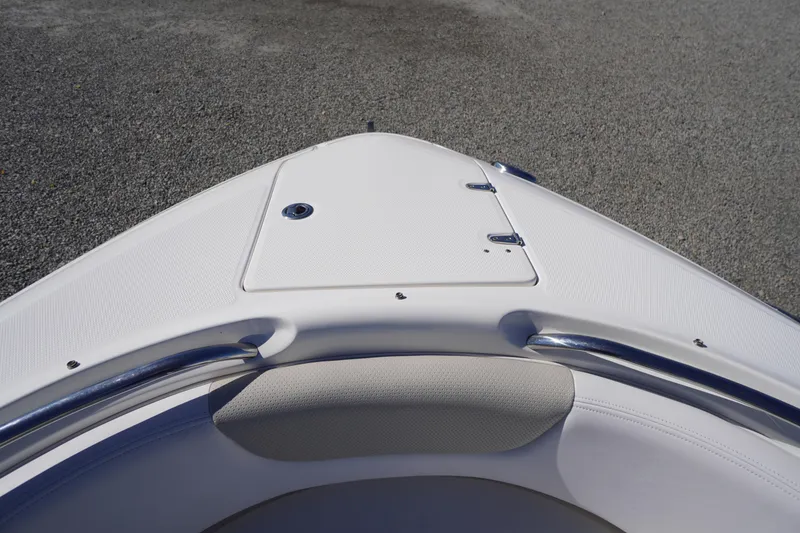 Slide: The Image of 2014 Chaparral 287 SSX boat bow with white seating and stainless steel rail. - 2
