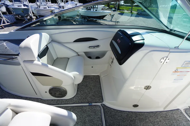 Slide: The Image of 2014 Chaparral 287 SSX boat interior with white seating and dashboard. - 23