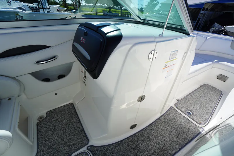 Slide: The Image of 2014 Chaparral 287 SSX boat interior with white seating and carpeted flooring. - 24