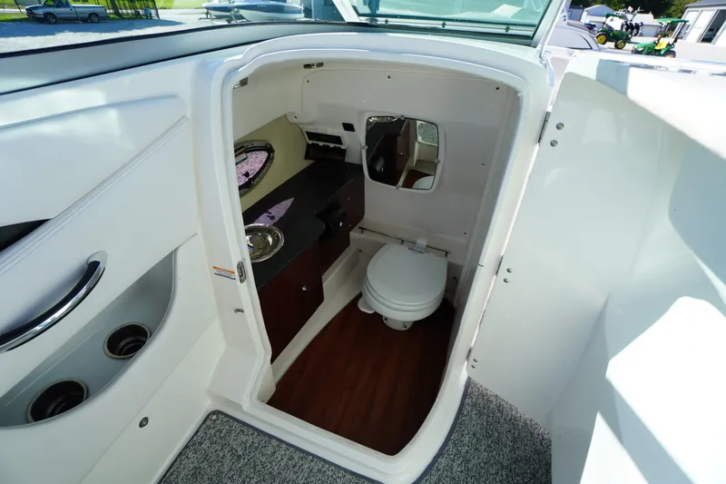 Slide: The Image of 2014 Chaparral 287 SSX boat interior with compact bathroom and modern amenities. - 26