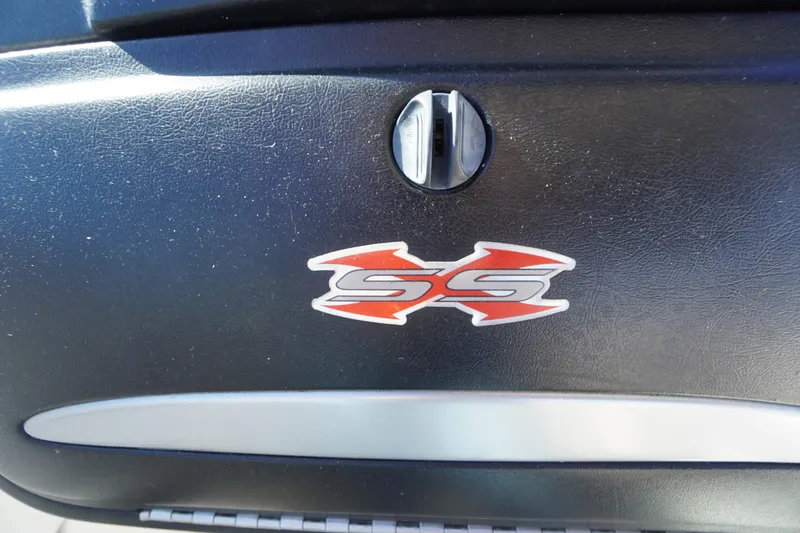 Slide: The Image of 2014 Chaparral 287 SSX logo on black surface, featuring red and silver design. - 28