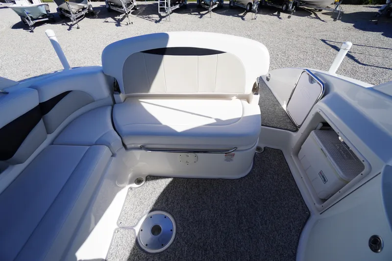 Slide: The Image of 2014 Chaparral 287 SSX boat interior with white seating and storage compartments. - 30